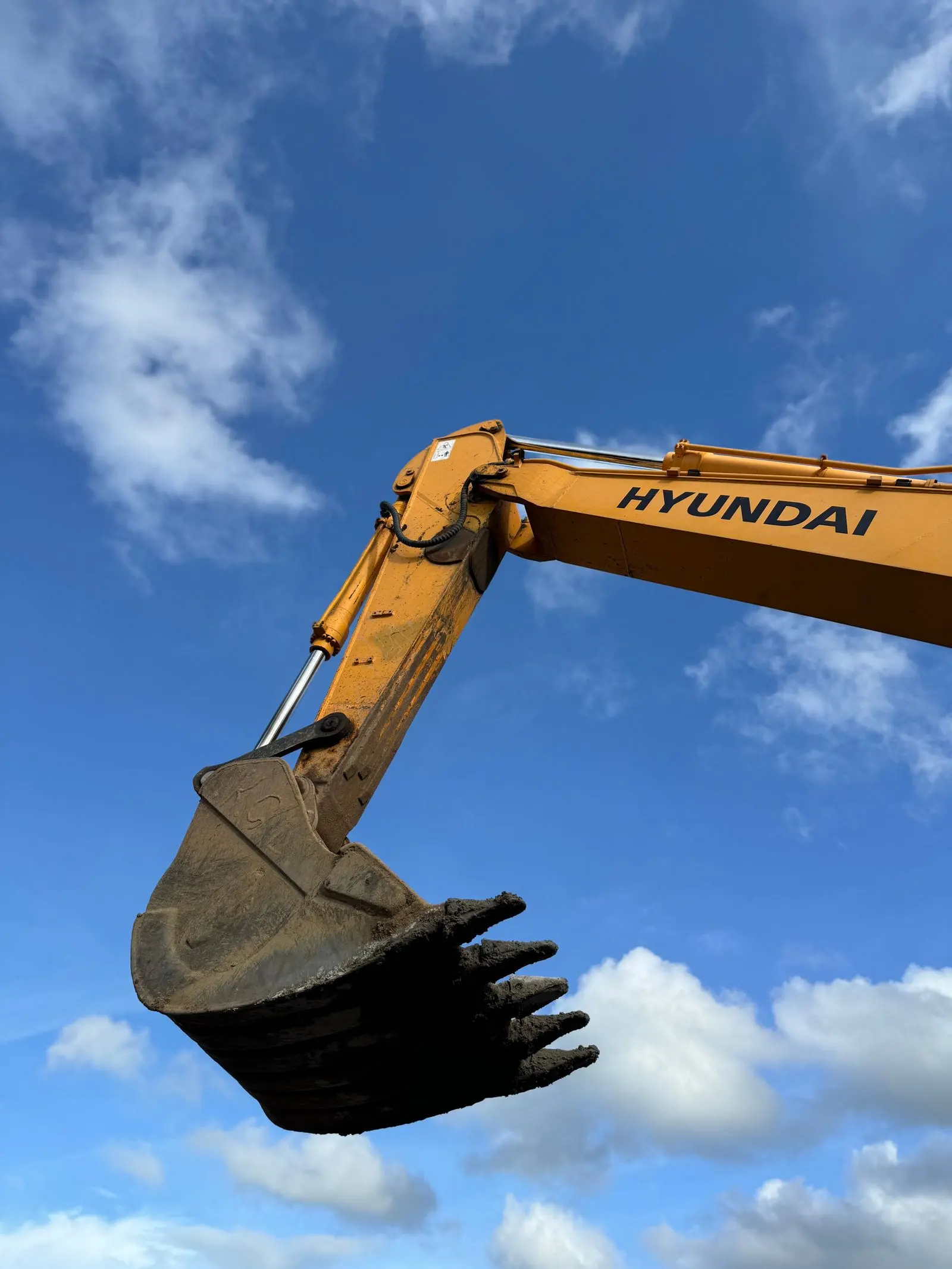 Excavator bucket against a blue sky